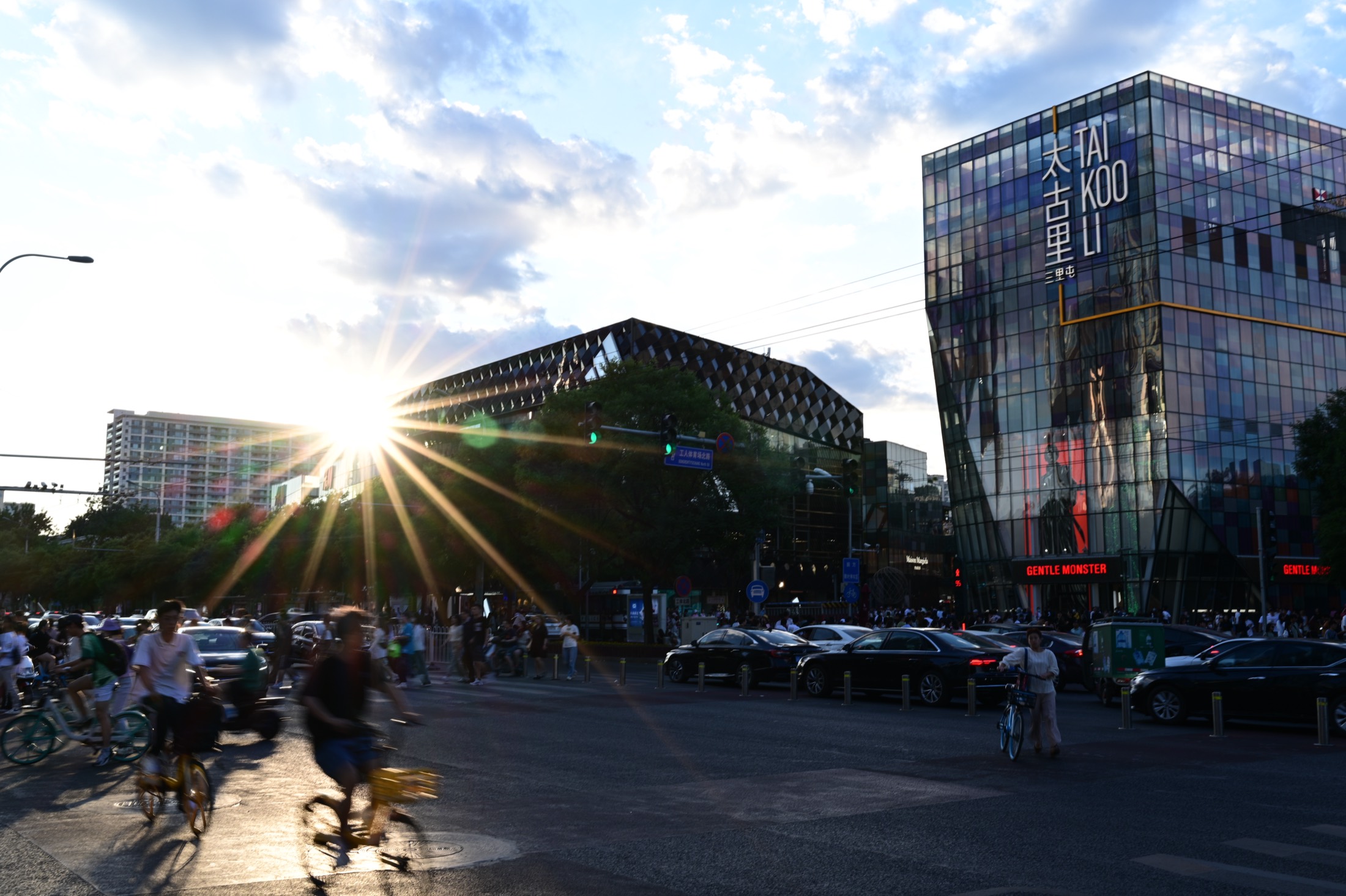 City street with sunburst and reflective building