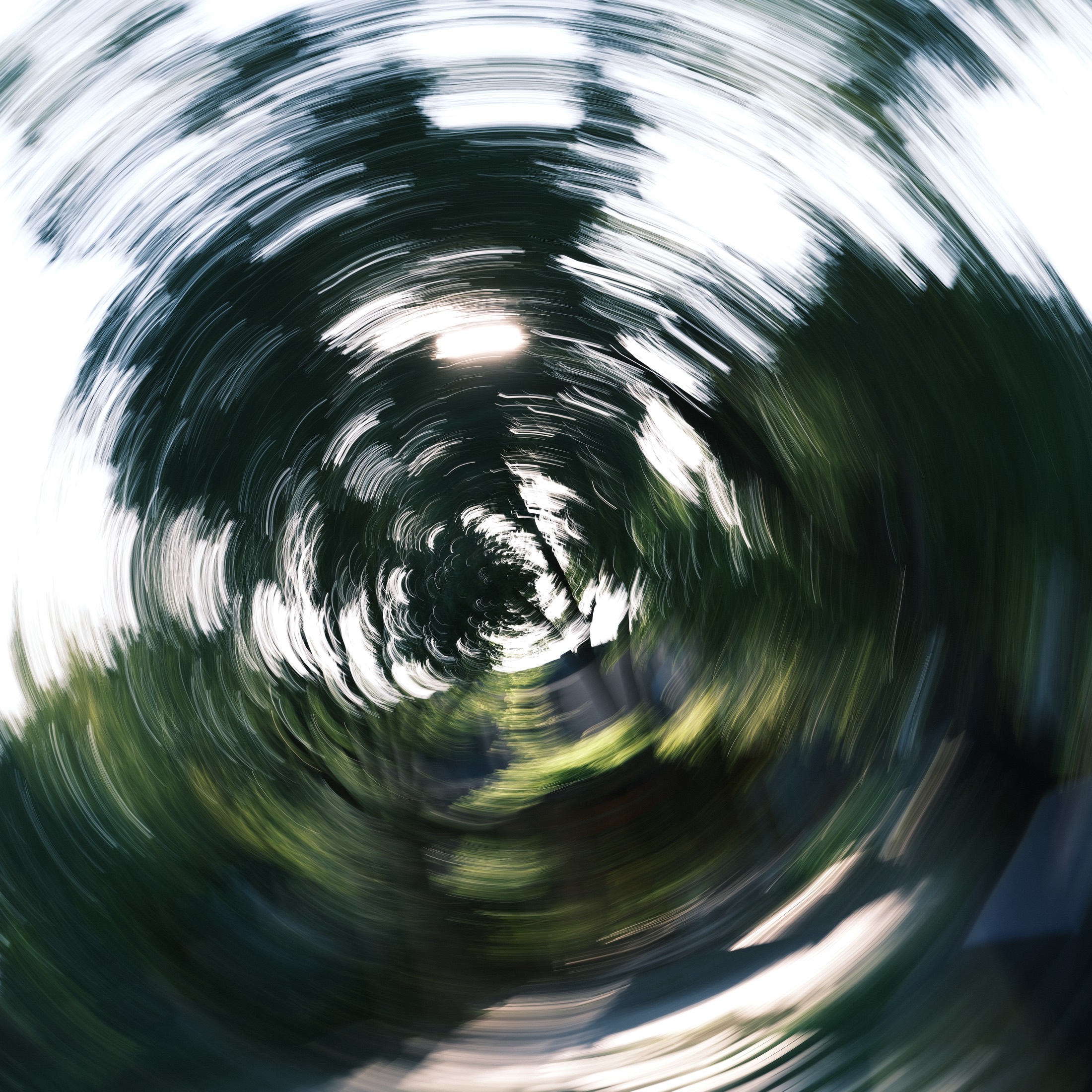 Green tunnel photographed with rotational motion blur